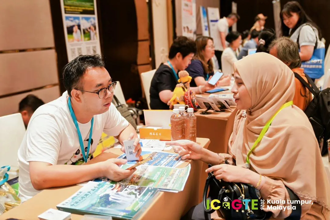 A face-to-face conversation about planning travel in China in Kuala Lumpur