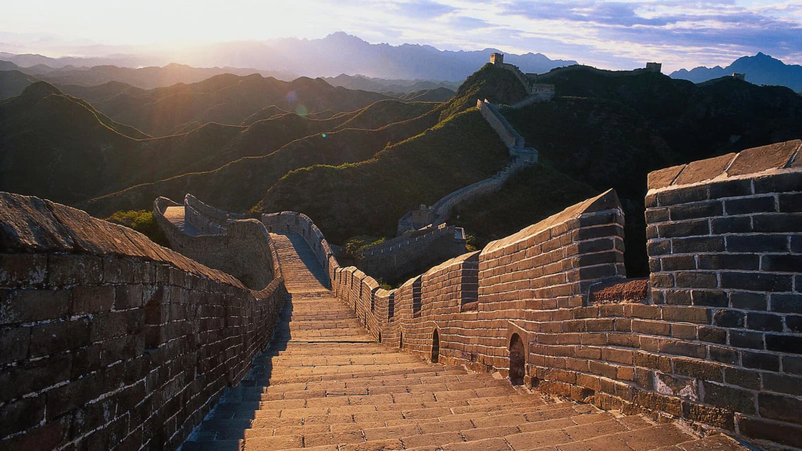 The Great Wall crossing mountain ridges near Beijing in warm evening light